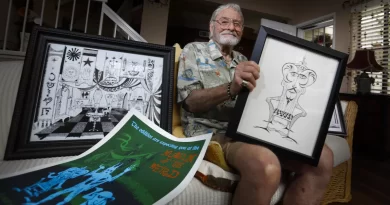 Rolly Crump, seen here in 2019, in his Carlsbad home surrounded by some of his designs for the Haunted Mansion. (Howard Lipin / The San Diego Union-Tribune)